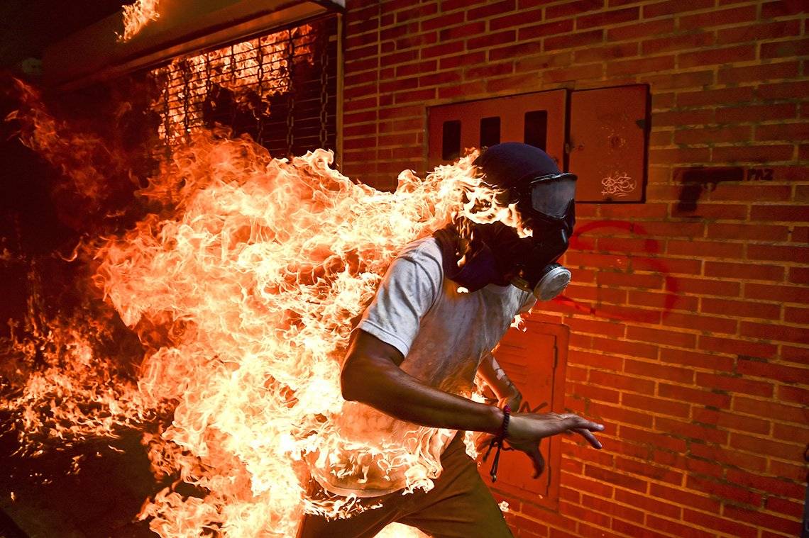 Venezuela Crisis, by Ronaldo Schemidt, captures 28-year-old José Víctor Salazar Balza ablaze.