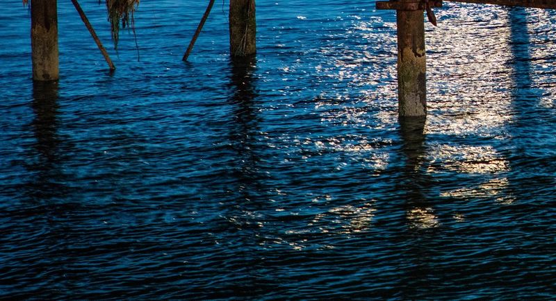 Dark blue sea by bridge structure