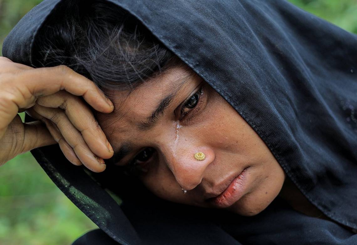 A close up of a crying woman as she waits for shelter in a refugee camp in Bangladesh.