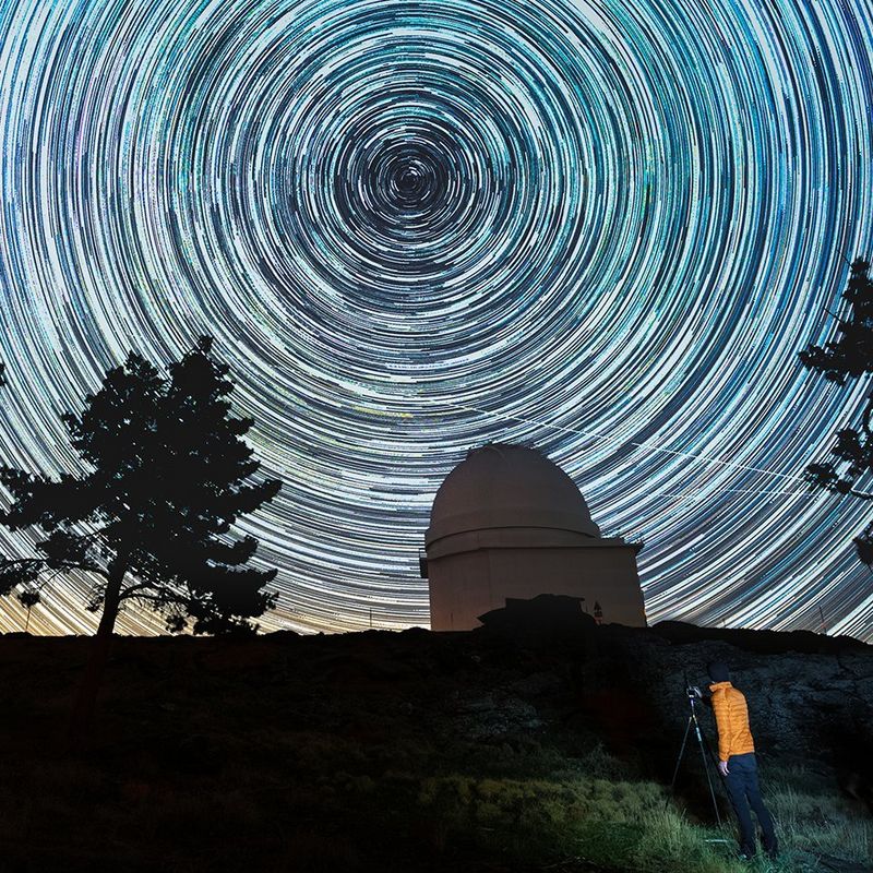 Canon EOS Ra on tripod with star trails in the night sky