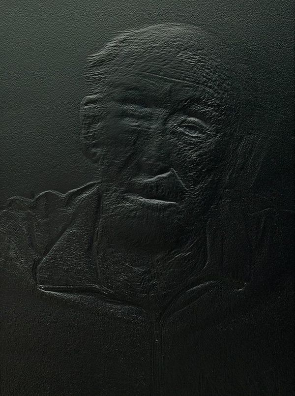 A photograph of a relief print. The print is a head and shoulders portrait of a man.