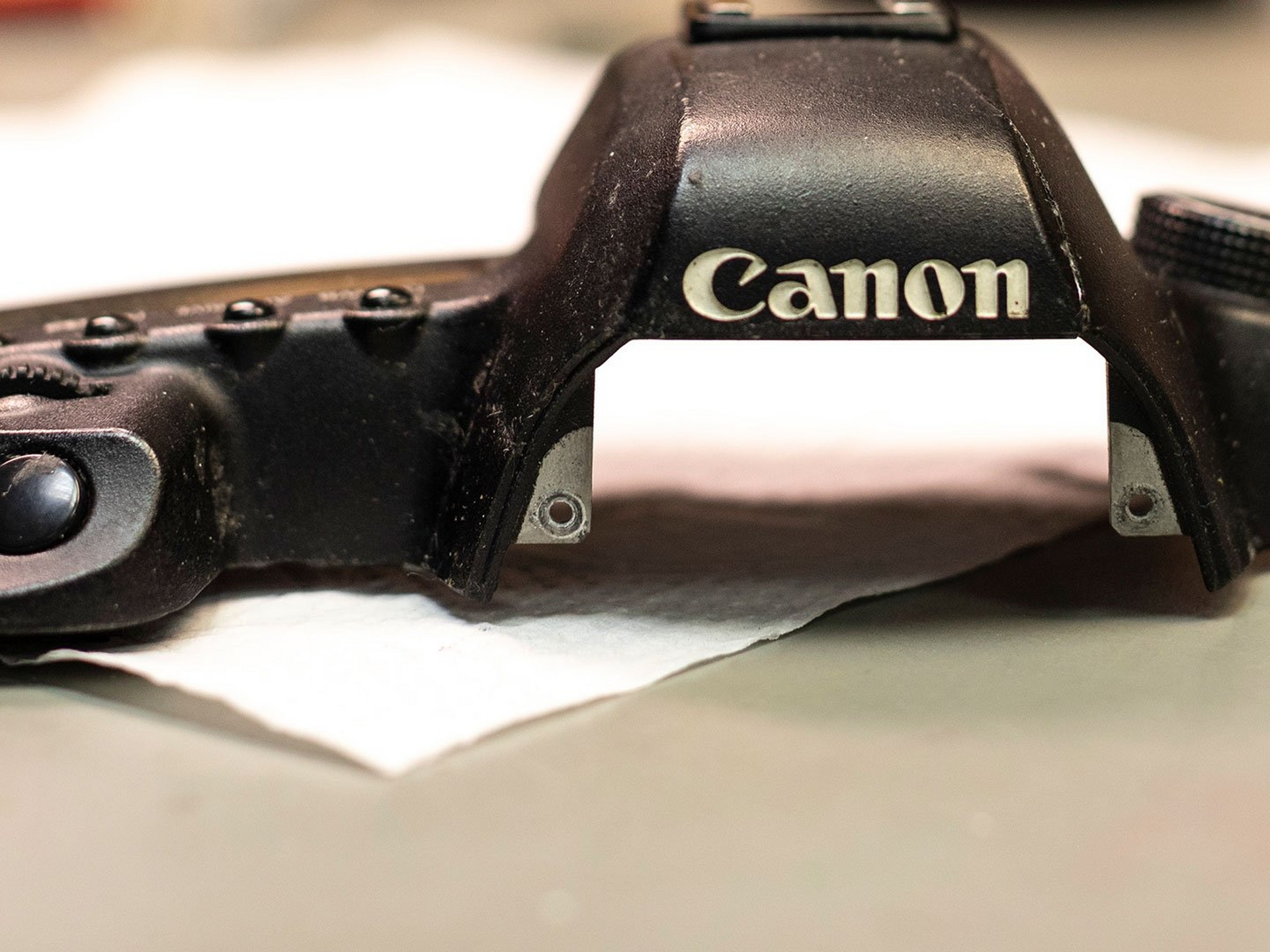 Canon EOS camera body top awaiting repair