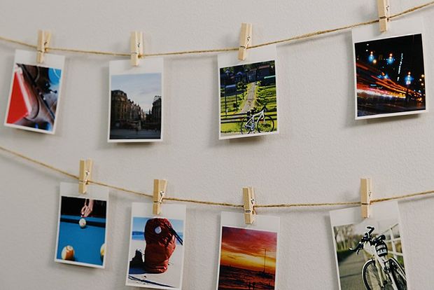 A garland of photos printed on the Canon SELPHY SQUARE QX10 hanging from the wall.