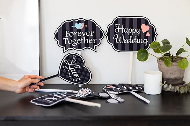 Printed decorations and hand-held signs for a wedding day.