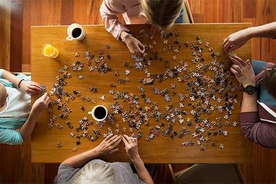 Group of four doing a puzzle