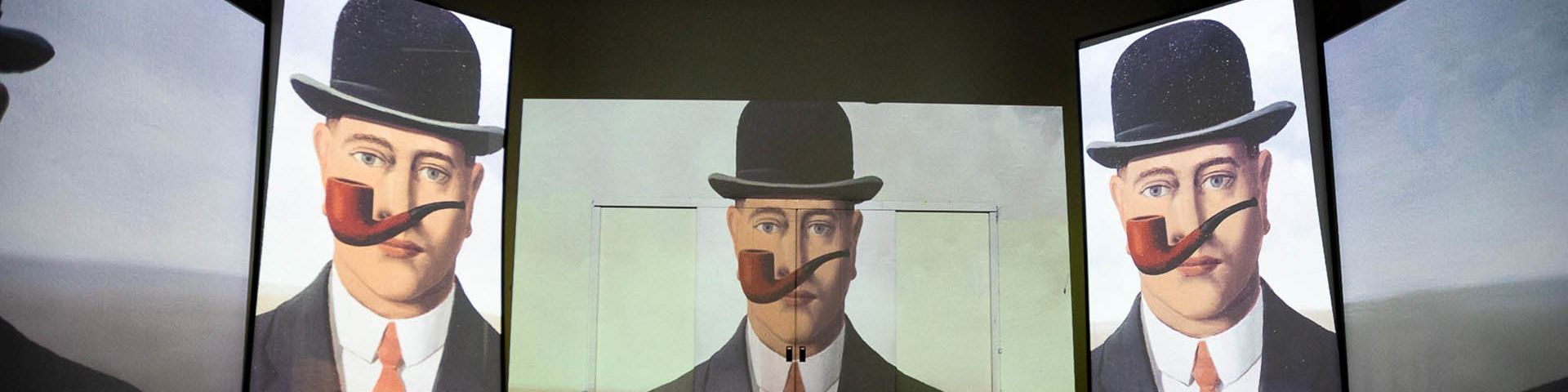 Magritte’s La Bonne Foi or ‘Good Faith’ projected three times side by side on the walls of the exhibition.
