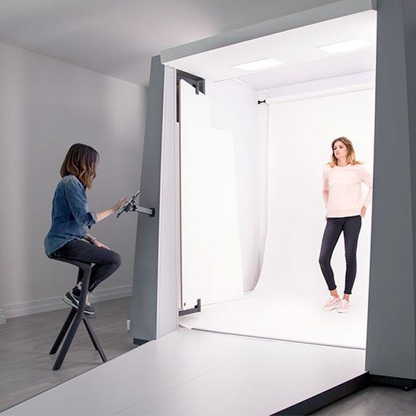 A model stands in a Styleshoots booth, as a stylist controls the shot with an Apple iPad.