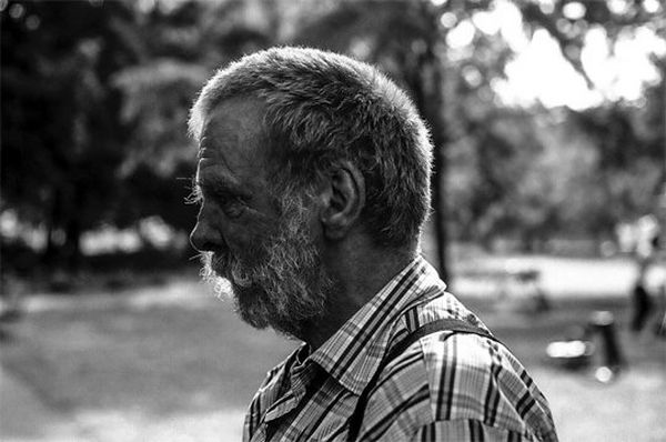 A bearded man in a checked shirt, shot in profile.