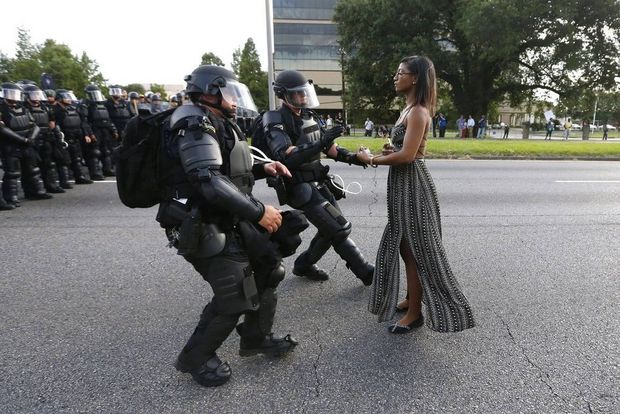 Taken on a Canon EOS-1D X showing protester Iesha Evans confronting police over African American civil rights police brutality.