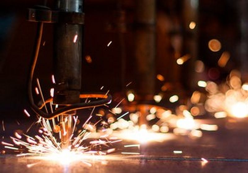 Sparks flying, as an industrial drill hits metal.