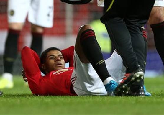 A Man Utd player lies on his back on the pitch, awaiting treatment. (Photo courtesy of Manchester United FC.)