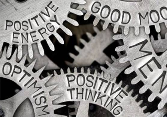 Interconnected cogs, engraved with the words 'good mood', ‘positive thinking’, ‘positive energy’ and ‘optimism.’
