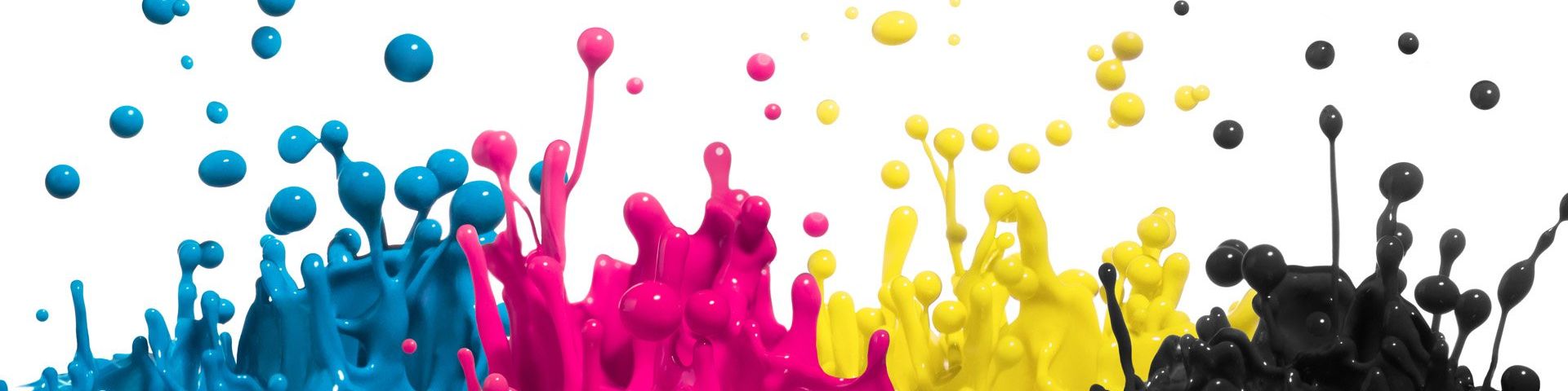 Four different colours of ink – cyan, magenta, yellow and black – splashing into the air.