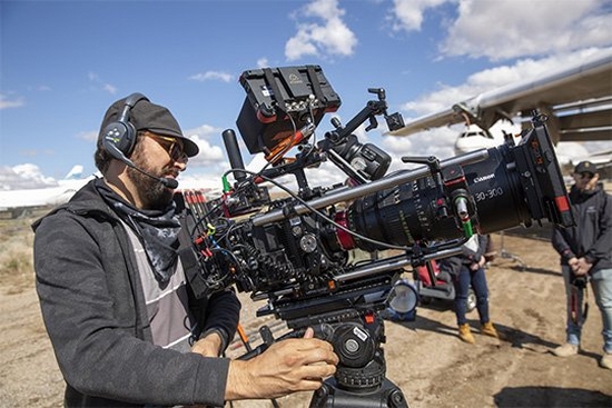 A camera operator using the Canon EOS C300 Mark III on an airfield shoot.