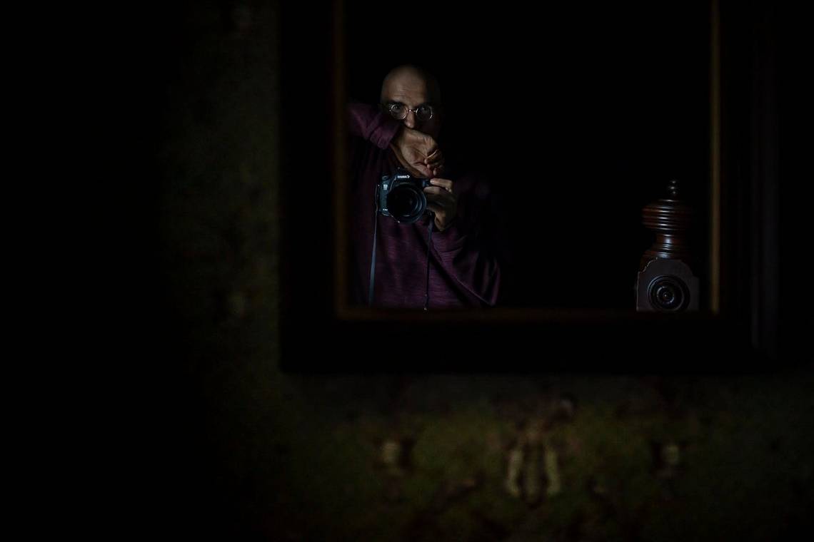 John Stanmeyer takes a self-portrait of his reflection in a mirror.