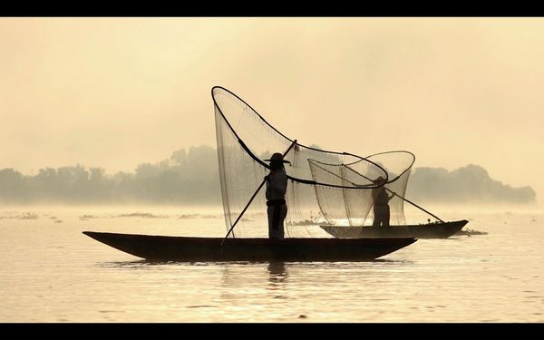 A video still of two traditional fishermen casting their nets, by travel photographer Joel Santos.