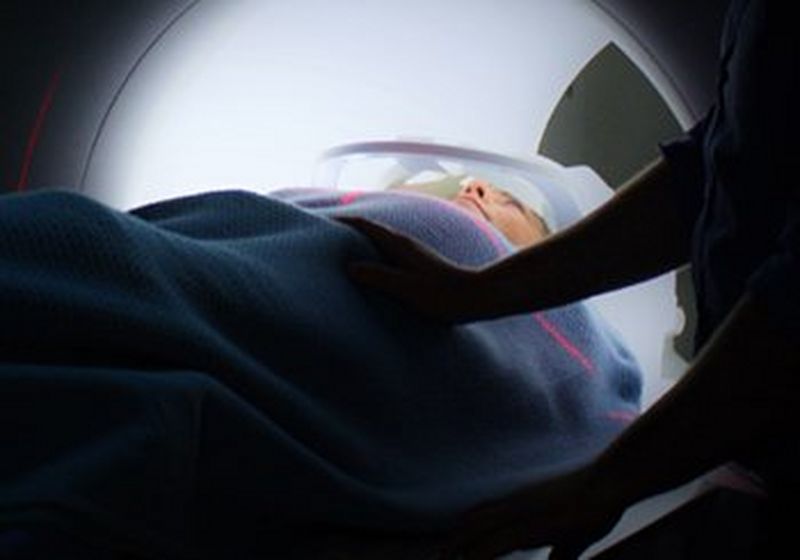 A woman entering a CT scanner