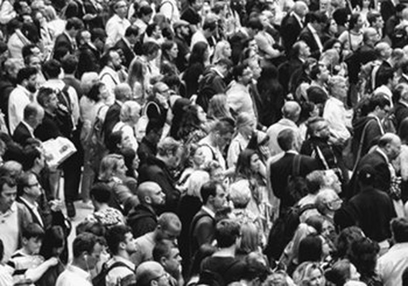 A crowd of people, photographed in black and white