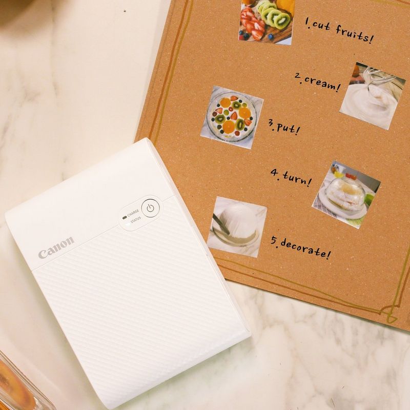 Canon SELPHY SQUARE QX10 Portable Colour Photo Wireless Printer, White Front View with a Photo Menu