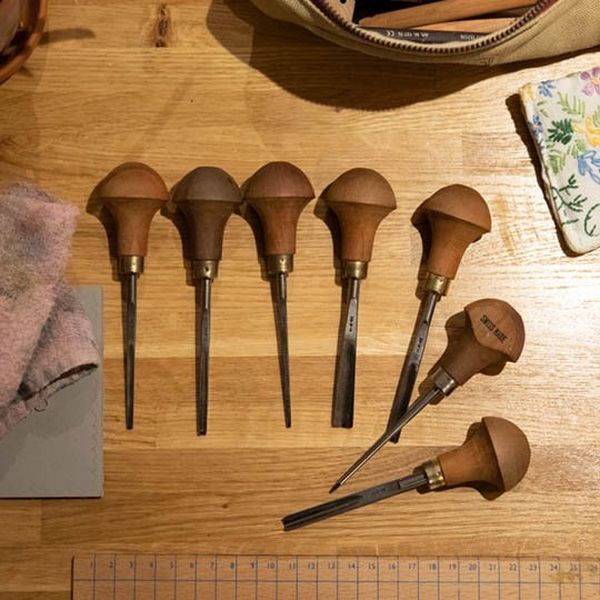 Lino-carving tools laid out on a table 
