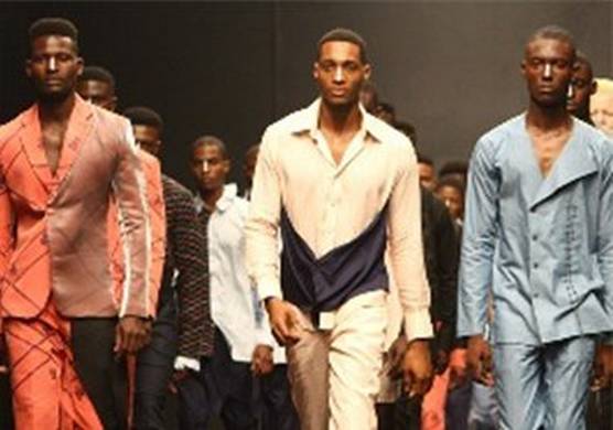 Male models walk down the runway in lines