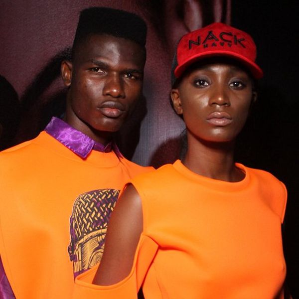 A male and female model, dressed in orange, side by side