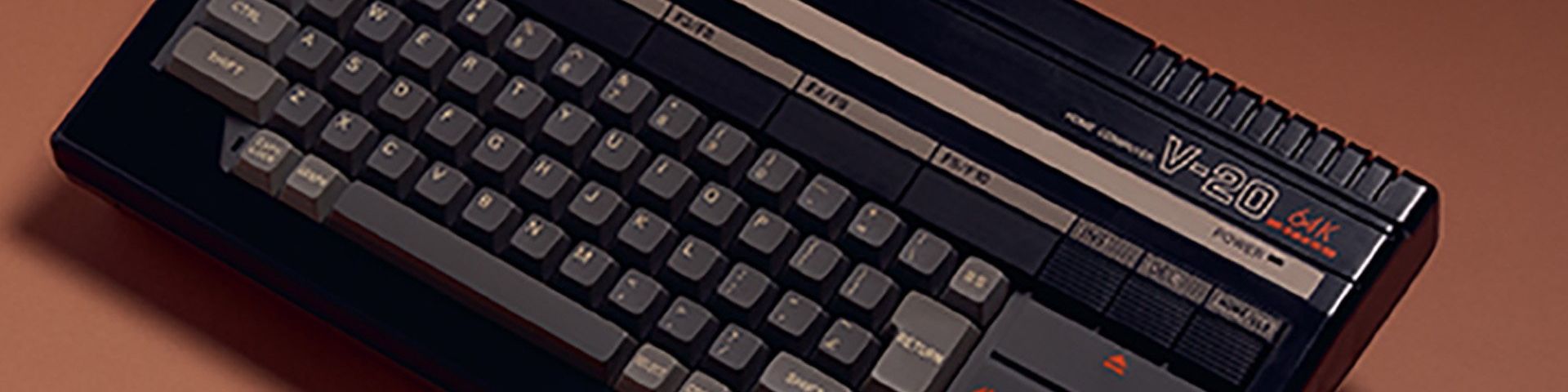 A close up of the Canon V-20 home computer, showing the text HOME COMPUTER V-20 65K, the power indicator and F keys. Image courtesy of Thames and Hudson