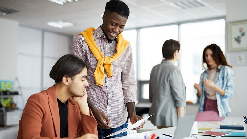 Work professionals in the office talking
