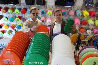 Owners of Alfa Discs looking at frisbee printed on with and Arizona flatbed printer