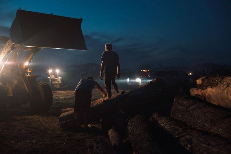 In camp, everyday tasks like cooking and chopping wood are done on the front line.