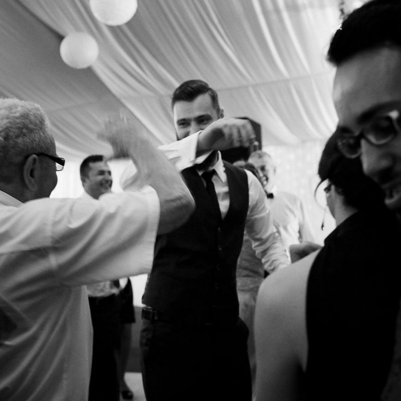 Scenes at Romanian wedding - Groom Dancing B&W Image - taken with a EOS 5D Mark IV