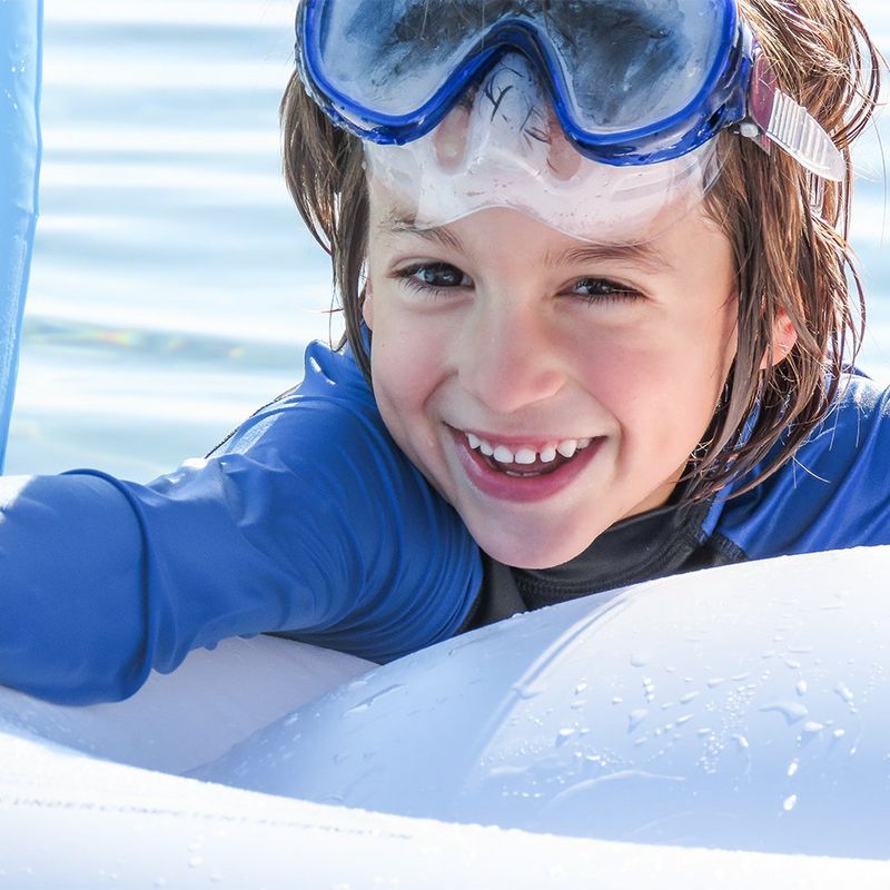 boy playing on water float on holidays