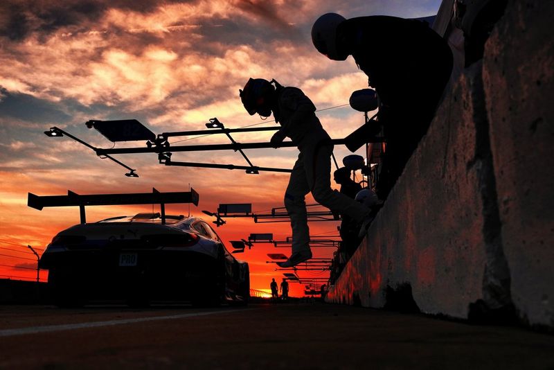 A racing driver silhouetted against the sunset jumps off a wall ready for the changeover at Sebring Raceway in Florida. Taken by Canon Ambassador Frits van Eldik on a Canon EOS R.
