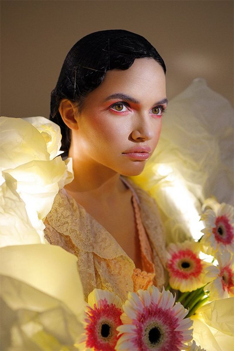 A model was a large paper garland with lights and flowers tucked into it. Photo by Guia Besana on a Canon EOS R.