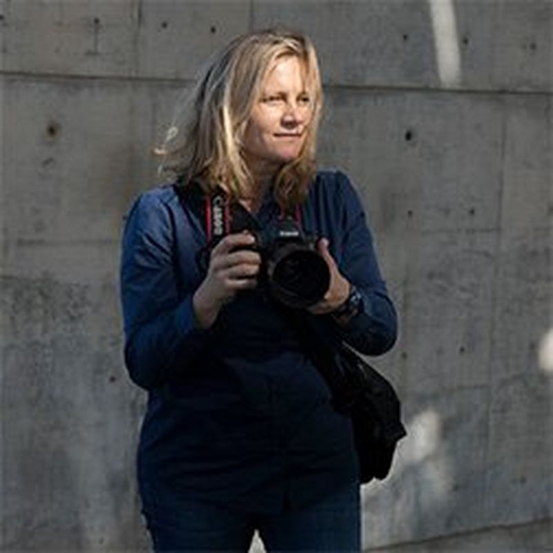 Canon Ambassador Guia Besana stands with a Canon DSLR.