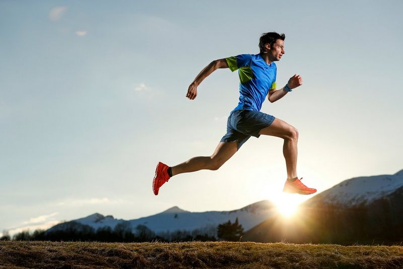 Trail runner Kílian Jornet Burgada sprints in front of a Norwegian mountain at sunset, taken by Canon Ambassador Jaime de Diego on a Canon EOS-1D X Mark II.