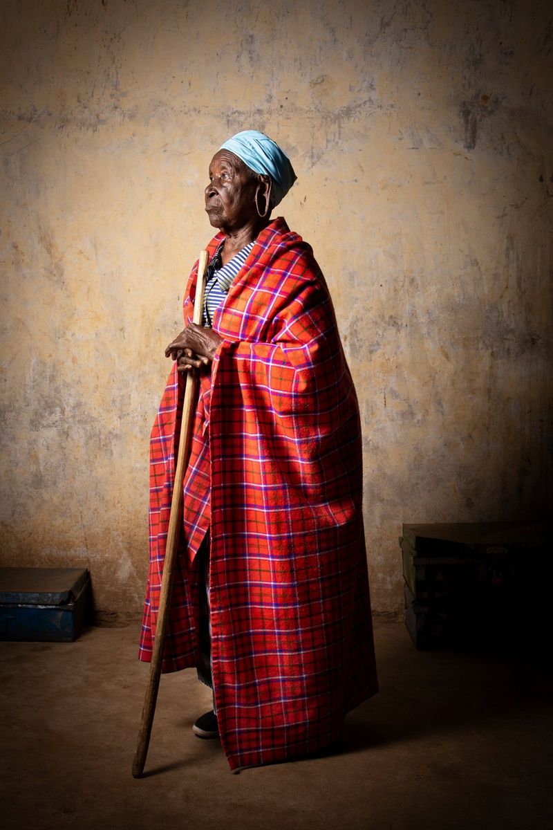 An 95-year-old Kenyan lady leans on a walking stick while gazing into the distance, taken by Lieve Blancquaert on a Canon EOS R.