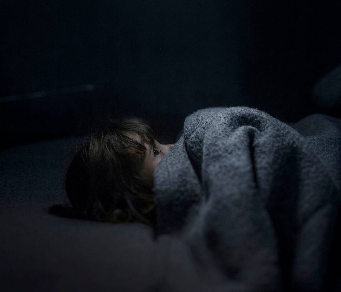 A young Jordanian girl tries to sleep in a refugee camp in Azraq, Jordan. Photo by Canon Ambassador Magnus Wennman.