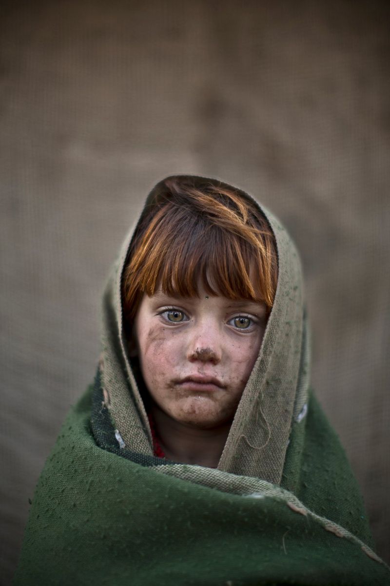 A six-year-old Afghan refugee near her family's mud home on the outskirts of Islamabad, Pakistan, photographed by Muhammed Muheisen on a Canon EOS 5D Mark III.