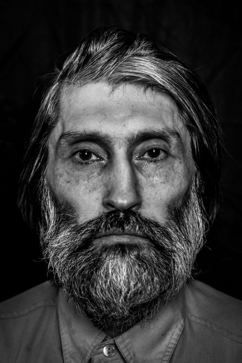 A black-and-white portrait of a homeless Russian man, photographed by Pavel Volkov on a Canon EOS 5D Mark II.