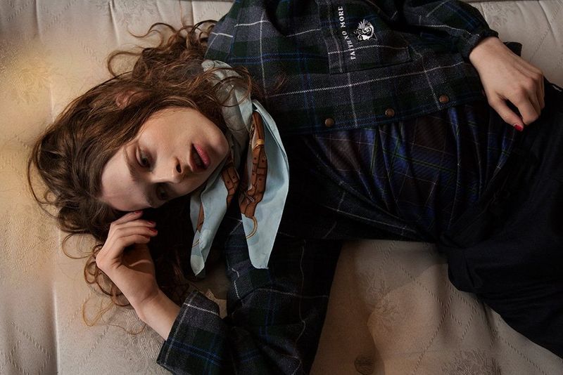 Musician Lauren Auder lies on a bed, staring wistfully off-frame. Photo by Wanda Jenkins on a Canon EOS 5D Mark II.