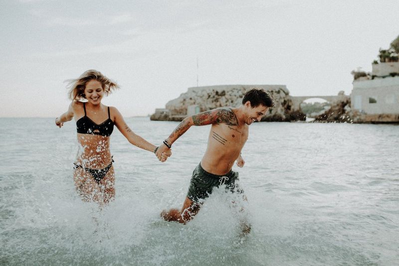 A couple running in the sea, photographed by Canon Ambassadors Julia Blumenthal and Gil Gropengießer on a Canon EOS 5D Mark III.