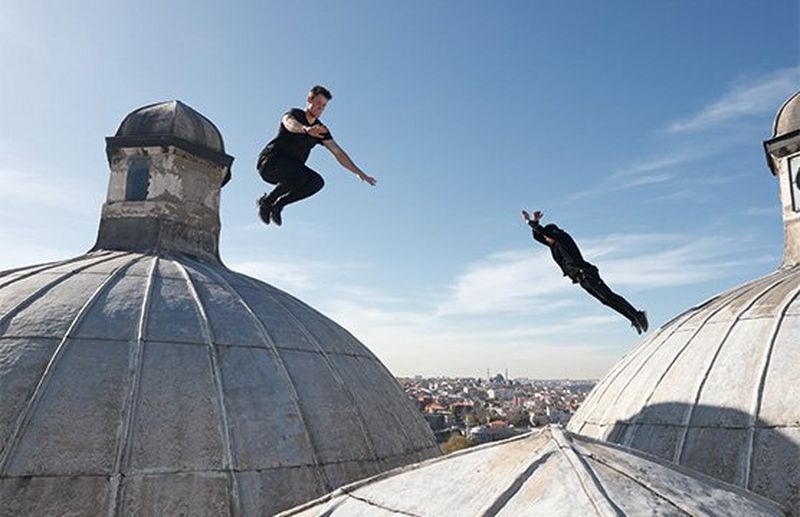 Two parkour athletes leap between domed rooftops in Istanbul.