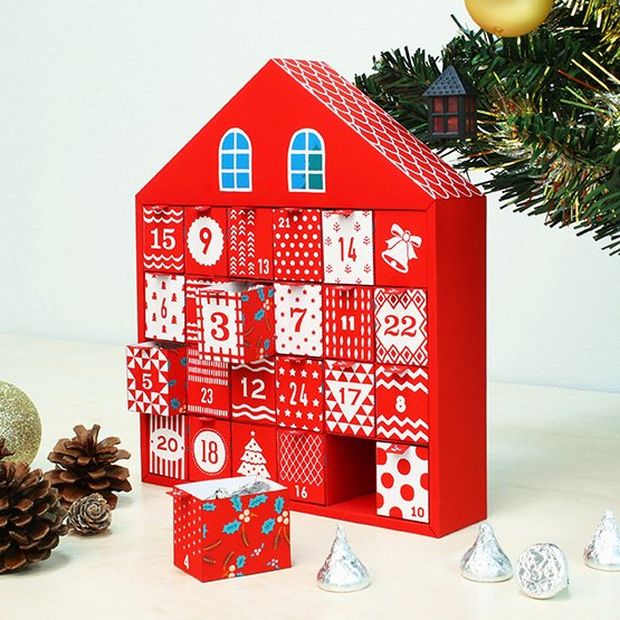 A homemade advent calendar shaped like a Christmas house.