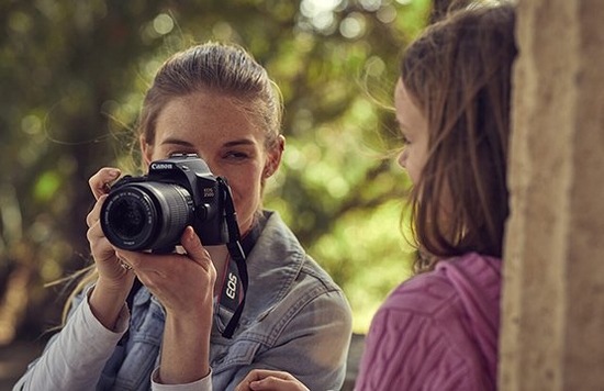 A mother and daughter pictured with a camera