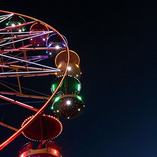 A ferris wheel illuminated against the night sky.