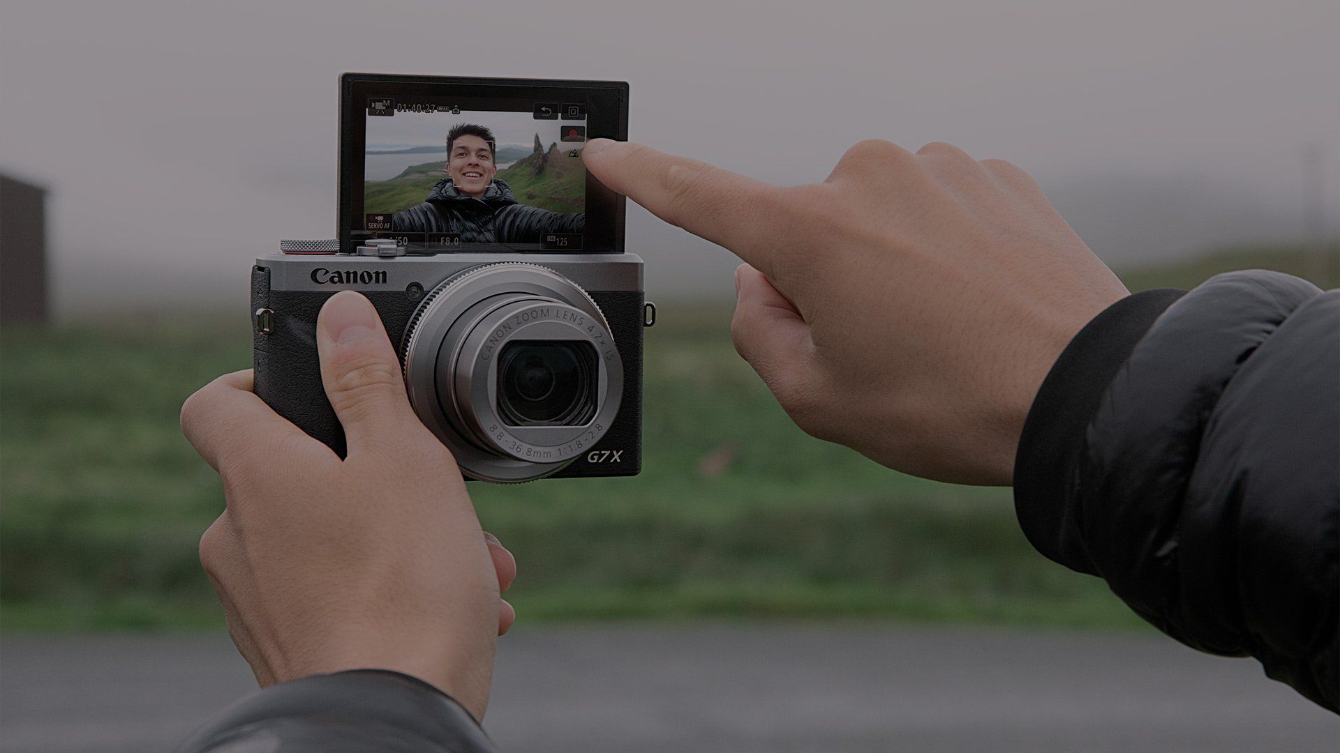 YouTube star and vlogger Mike Gray presses the Record button on the Canon PowerShot G7 X Mark III's touchscreen.