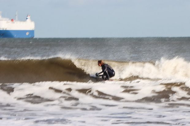 A zoomed-in shot of a surfer blurred by camera shake
