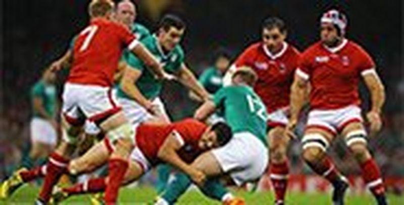 A Canadian player tackles an Irish player in a rugby match. Photo by Richard Heathcote.