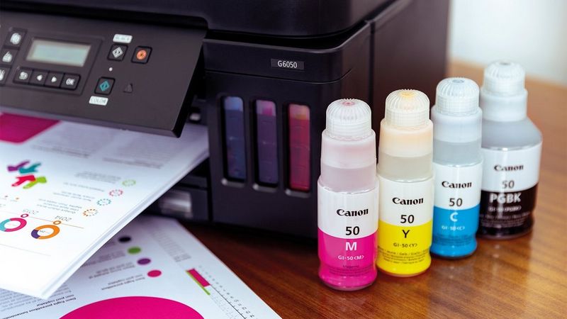 The Canon PIXMA G6050 with four vivid ink bottles for the refillable ink tanks.